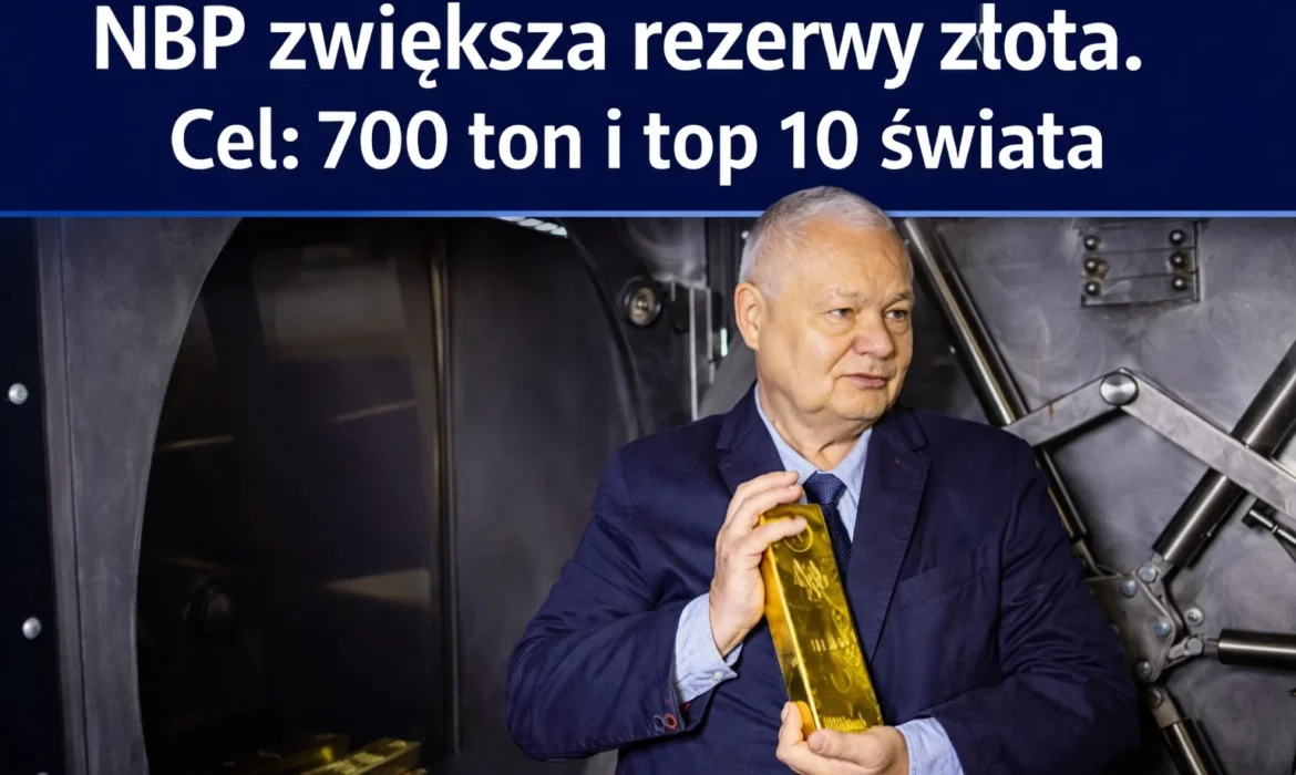 Prezes NBP Adam Glapiński prezentuje sztabkę złota na tle skarbca. Narodowy Bank Polski zwiększa rezerwy złota do 700 ton, wzmacniając bezpieczeństwo finansowe kraju.